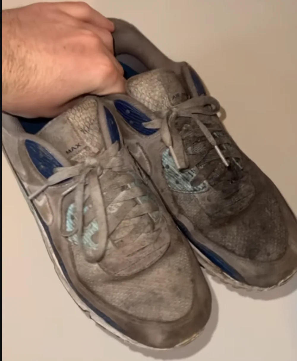 The same Air Max 90s on arrival, grey with grime